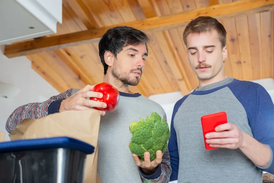 Couple checking their groceries and a coupon app on a smartphone